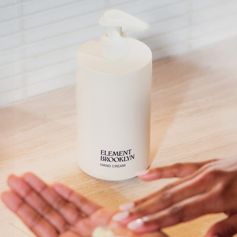 hand cream bottle lifestyle with blurry hands